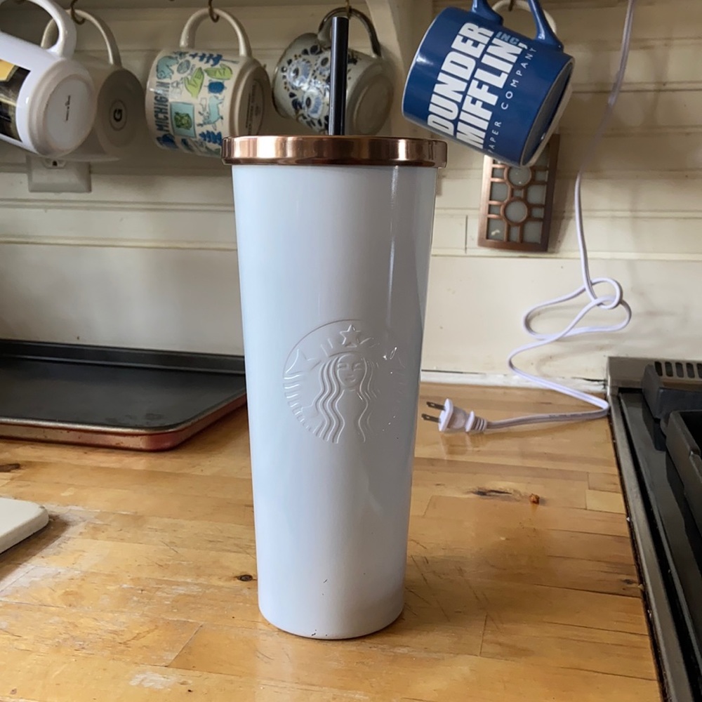 Starbucks white stainless with gold lid.